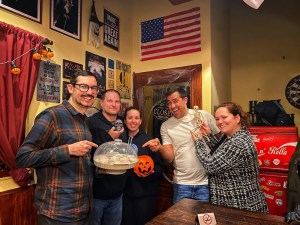 Post-game photo or David, Richard, Heather, Jonathan, and Sasha in a Boston pub holding a plate of donuts.