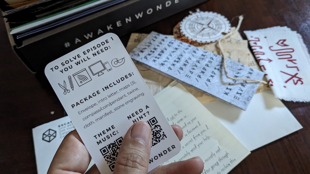 An assortment of puzzle items and a card with QR codes for music and hints.