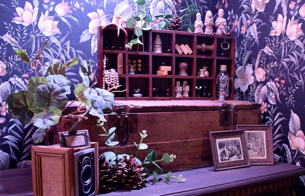 A table covered in boxes, photos, trinkets, and planets.