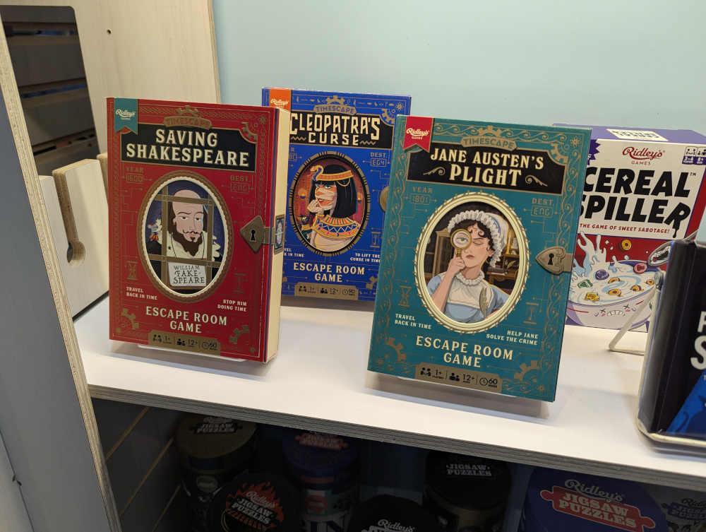 Copies of three boxed escape games from the Timescape series, themed after Shakespeare, Cleopatra, and Jane Austen.