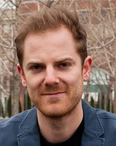 moritz, man with dark blonde hair, short stubble beard, and a dark blue jacket