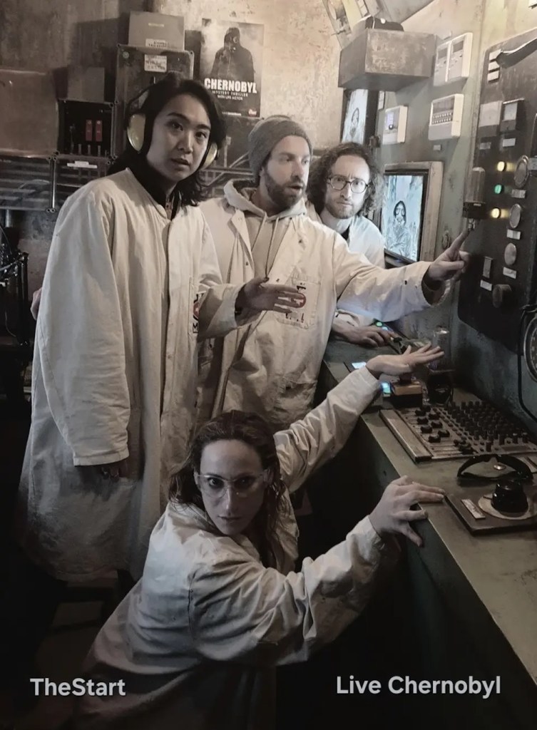 4 people in lab coats looking concerned of some old electronic equipment. The bottom of the photo is labeled, "TheStart, Live Chernobyl."