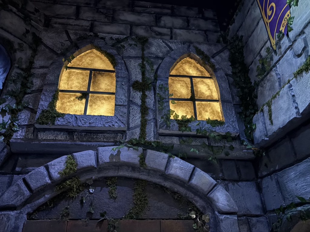 Illuminated windows in a castle wall.
