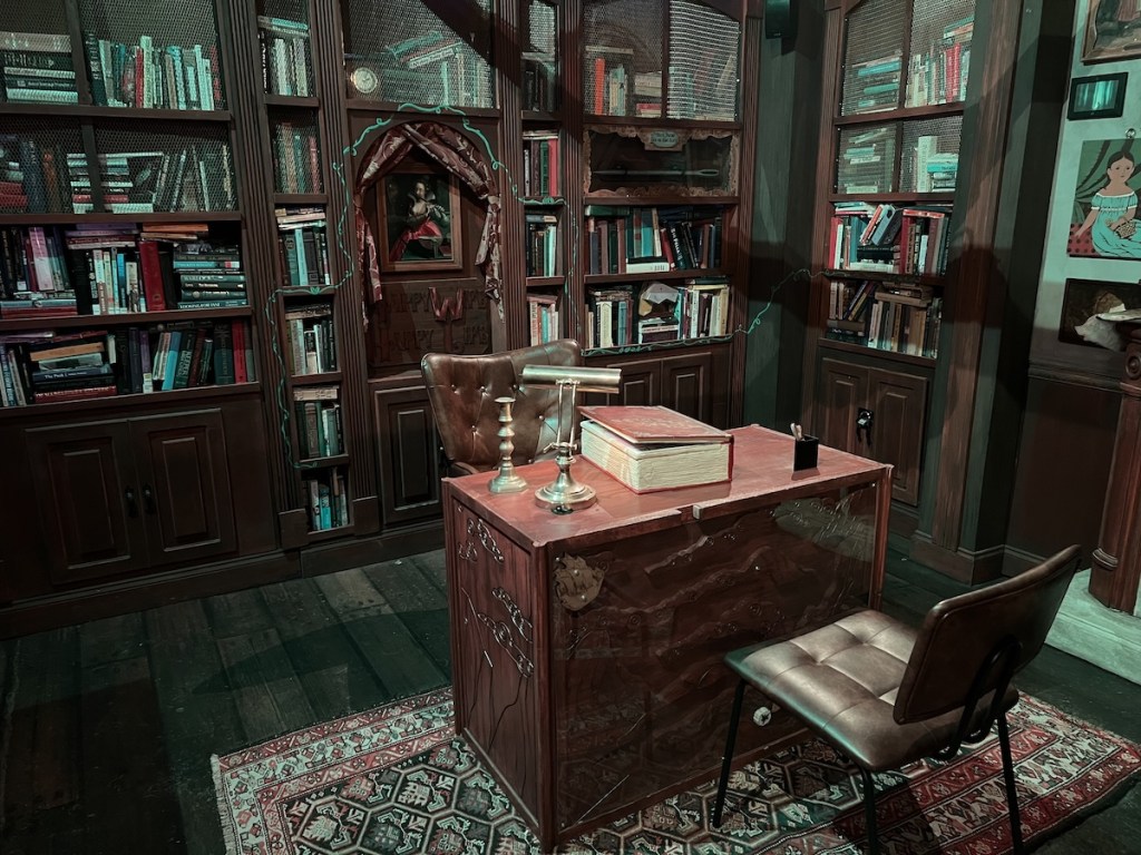 An eclectic study with a large tome sitting on the desk.