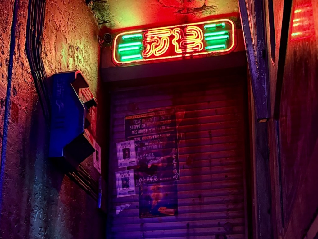 A cyberpunk alleyway, heavily worn, illuminated by a neon sign.