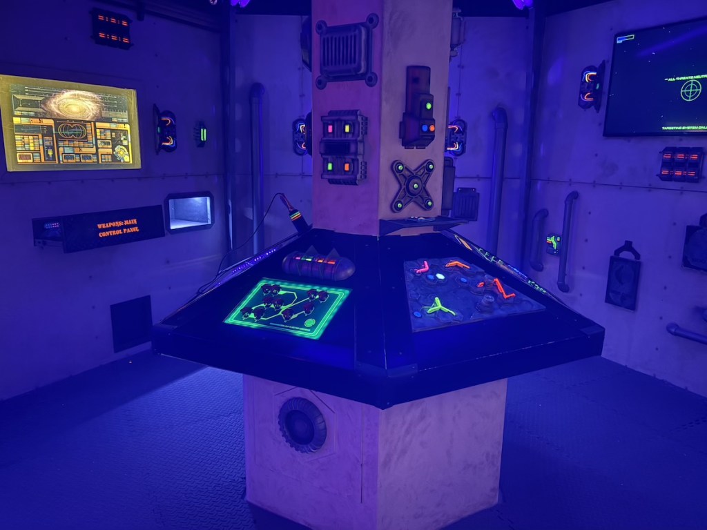 The helm of a space ship filled with glowing screens and buttons.