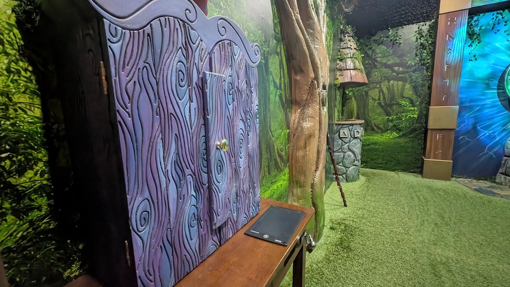 Closeup of a wood chest and a boogie board in an enchanted forest.