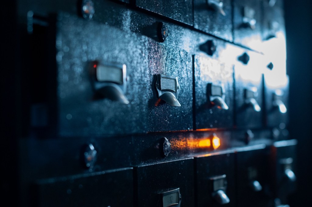 A card catalogue with an orange illuminated light.