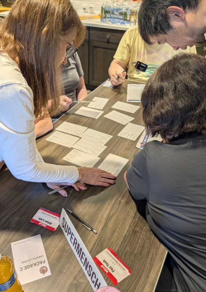 A team working on puzzles themed around super hero profiles.