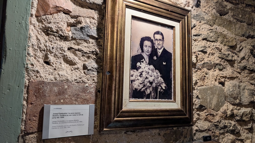 A black and white photo of Josep Fontcalda and his wife hung on the wall of a museum.