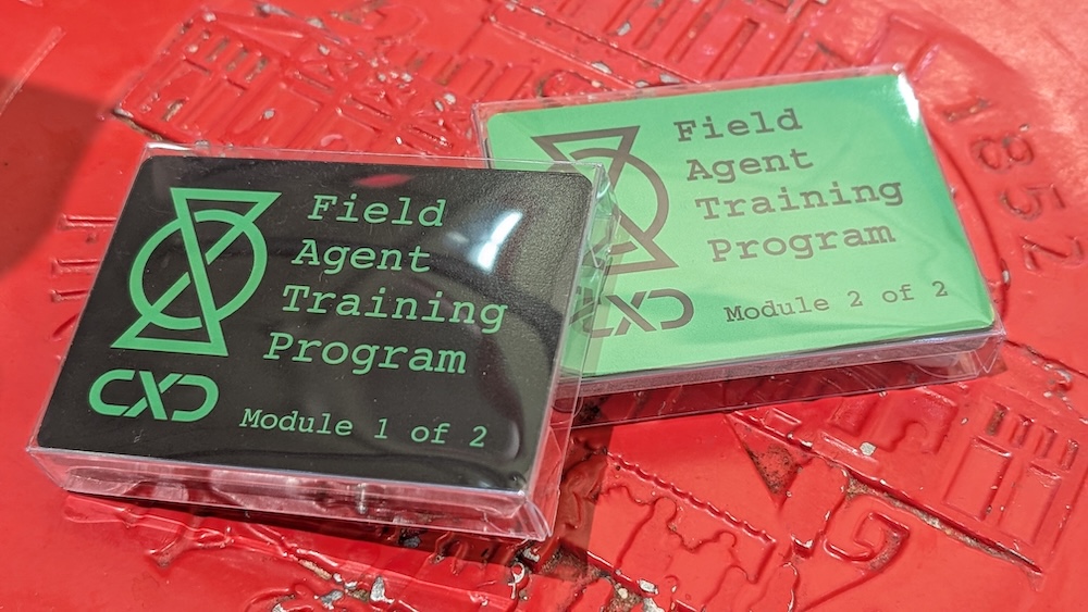 Closeup of CXD "Field Agent Training Program" packets purchased from a vending machine.