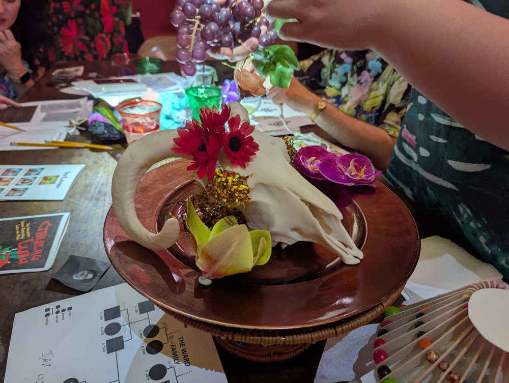 The skull centerpiece craft in progress, with puzzles being solved in the background.