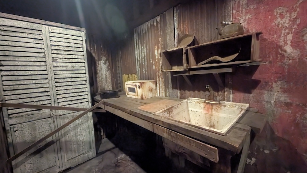 A dingy kitchenette in a rusty, shop-like space.