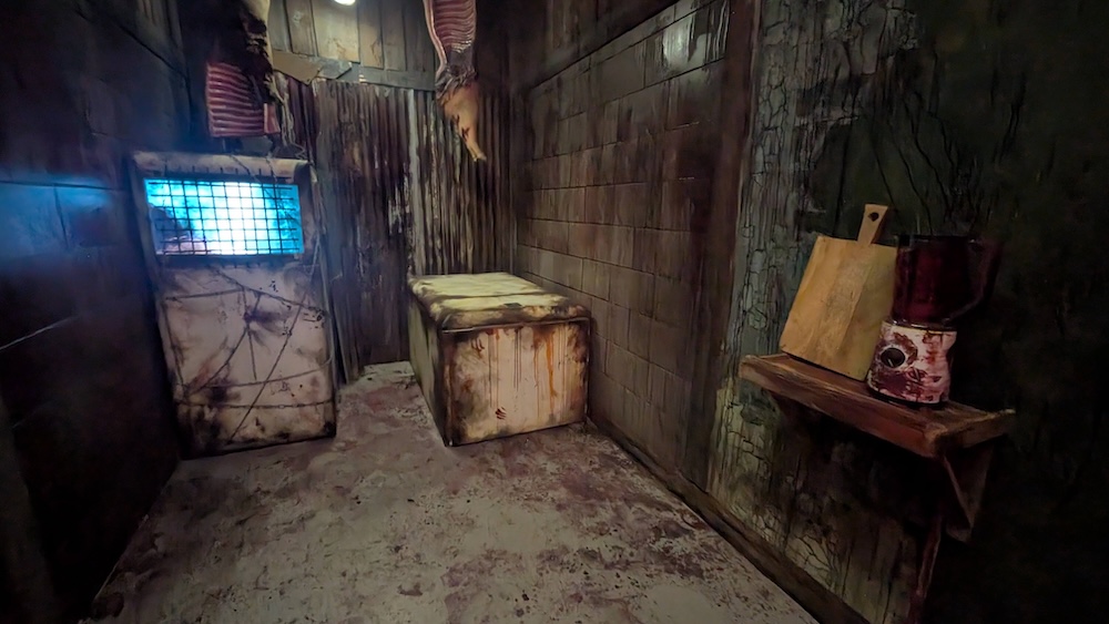 A rundown basement with assorted items, they look like they are covered in grime.