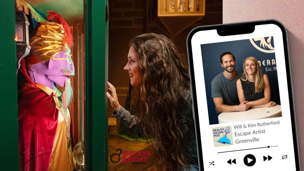 girl with long wavy hair smiling and peering into a glass box with a muppet inside dressed like a fortune teller with a gold turban and red cape. There is an iphone with an image of man and woman posed together and smiling.