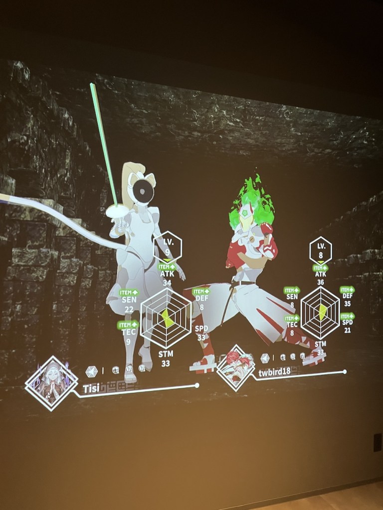 Two characters are side by side, their faces obscured by their masks. On the left, an all white cat fencer with a big blonde ponytail, on the right a karate fighter with red oni horns, green fire coming its head and shoulders, wearing a white outfit with red accents. Underneath the characters, is the corresponding player name and helper character icon. The fencer has a nun-esque character with arms clasped in prayer, while the karate fighter has a red haired fighter. Each character has a hexagonal display of character level and 6 statistics: ATK, DEF, SPD, STM, TEC, and SEN. Some of the stat abbreviations have "ITEM UP" over them.