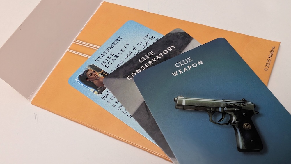A small stack of Clue cards including: a gun, the conservatory, and Miss Scarlett sitting atop a card-sized envelope illustrated to look like a file folder.