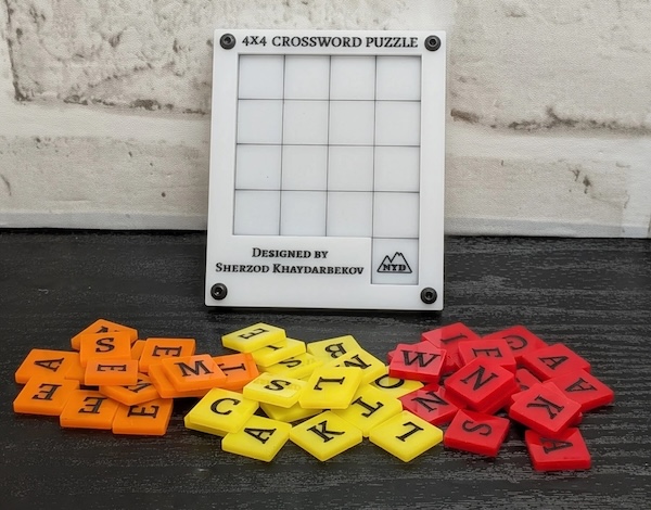 A 4 by 4 slide puzzle grid with 4 different sets of colored tiles laying in front of it.