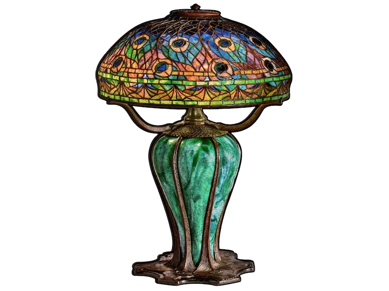 An assembled wooden jigsaw puzzle that looks an old lamp with a stained glass shade.