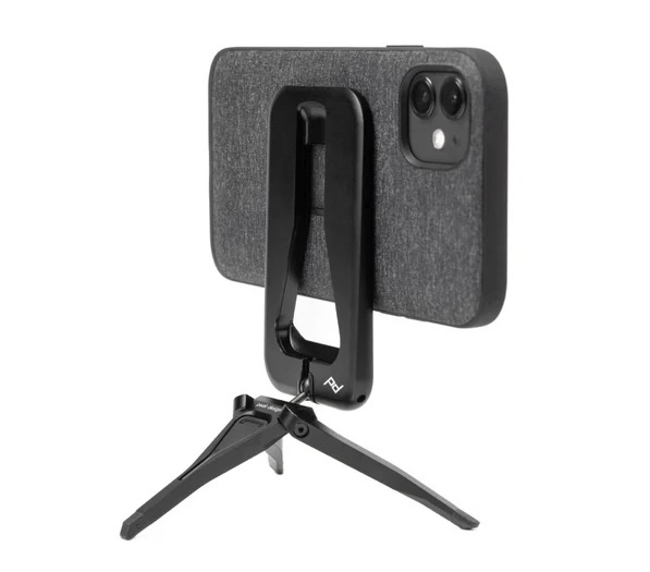 A metal tripod magneted onto the back of a phone