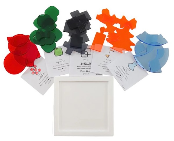 A single white puzzle frame, and 5 different sets of packing puzzle pieces.