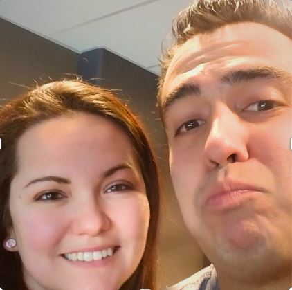 woman with straight brown hair smiling next to man with spikey brown hair