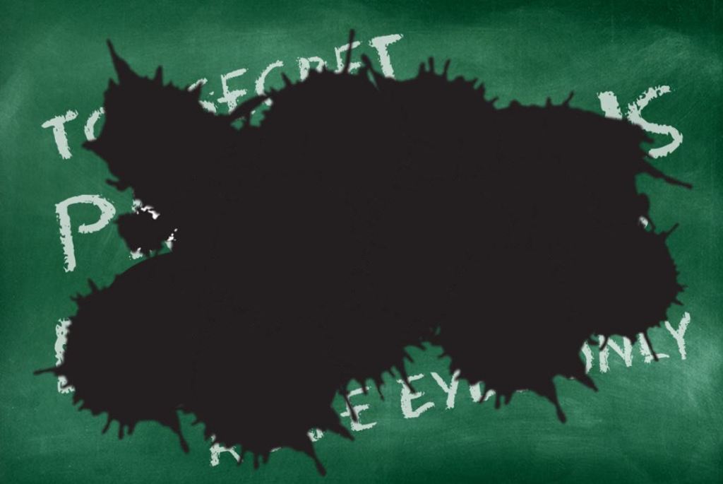 chalkboard with message obscured by black splotch