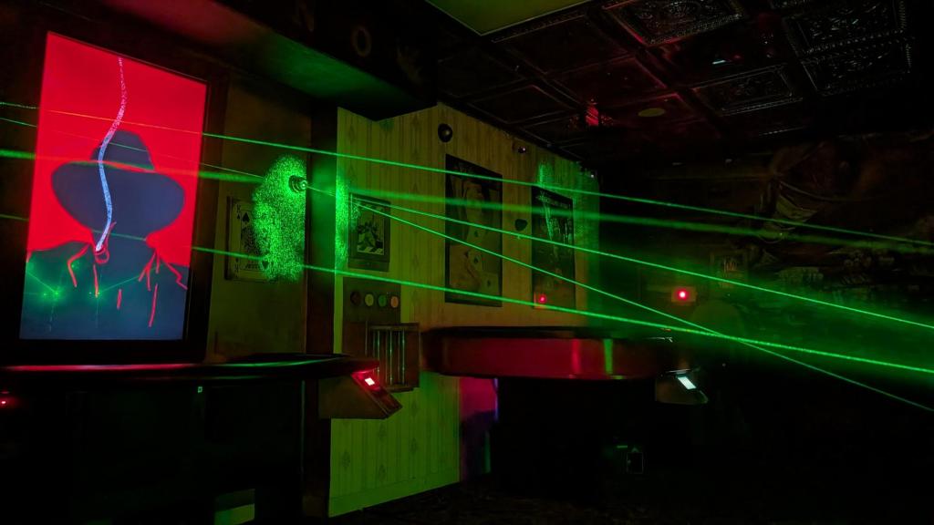 A dark casino with green lasers crossing the space