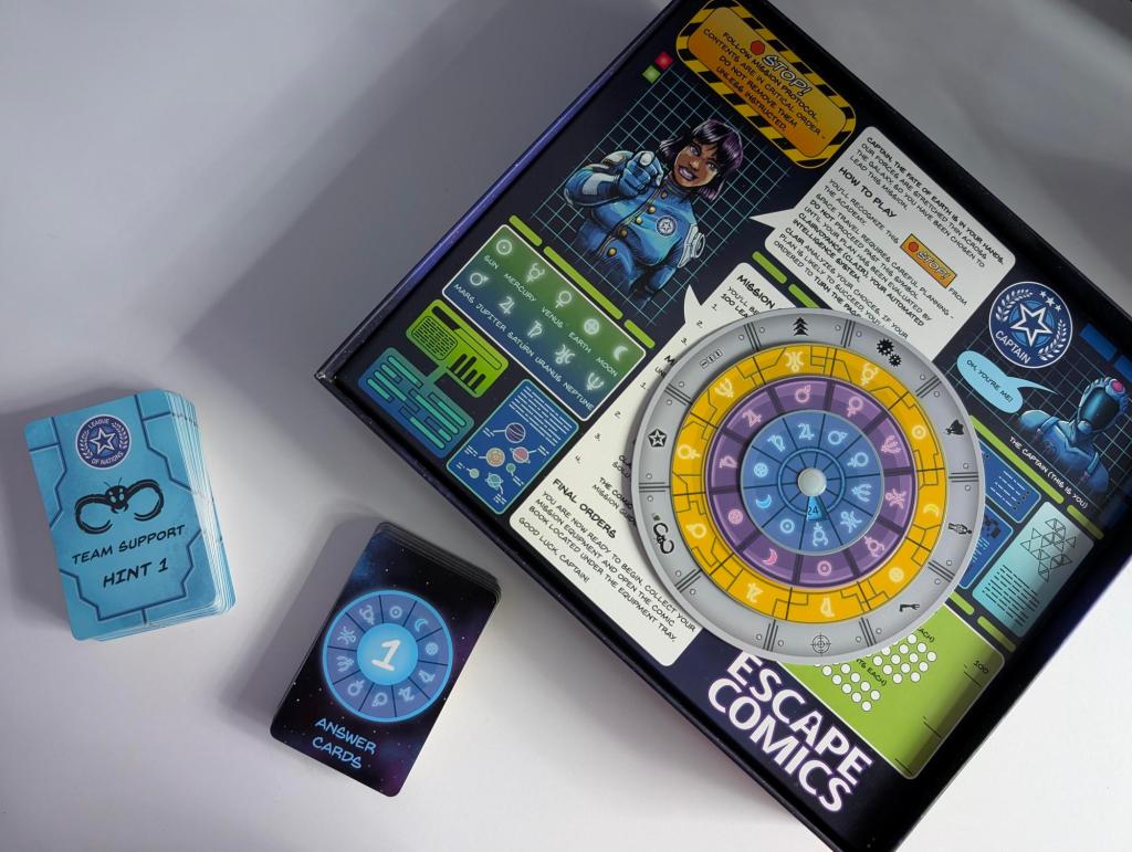 The inside of the Escape Comics game box containing thematic answer cards, hint cards, a decoder wheel, and basic game instructions.