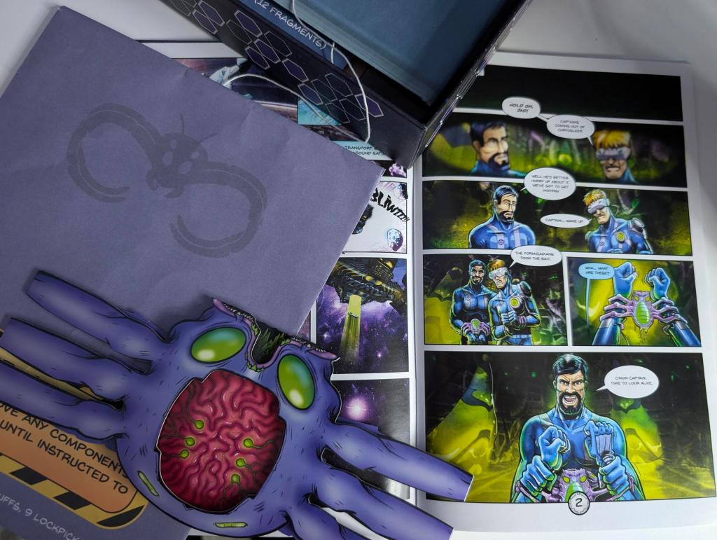 Pieces of the Escape Comics game, including a large alien bug, a closed purple envelope, and the first page of the comic depicting a space superhero.