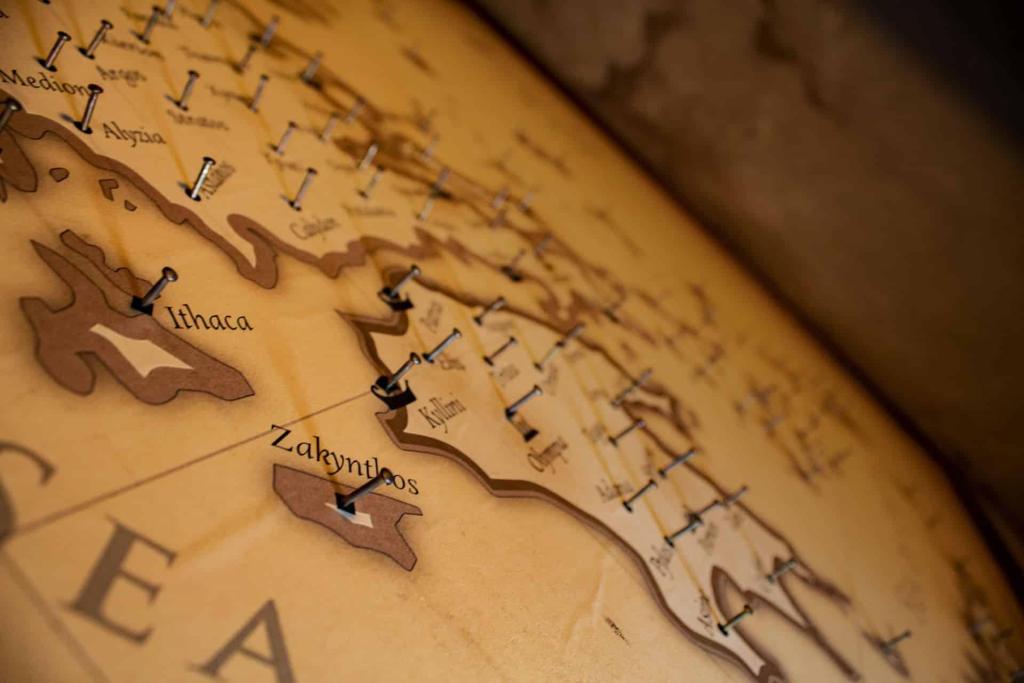 A map of Greece with nails protruding from specific cities