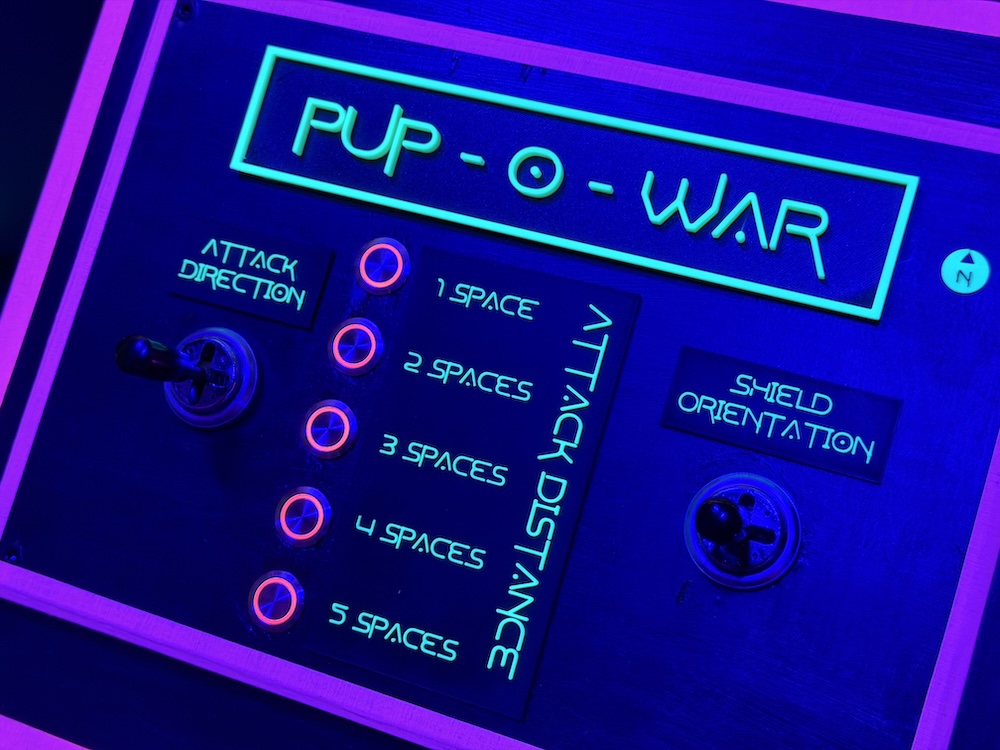 A control panel labeled, "Pup-o-War" with a series of buttons and a pair of directional controls.