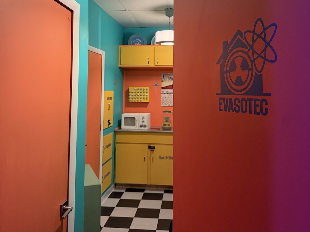 Opened door for a Evasotec home, inside is a blue, yellow, and orange 1950s style home.