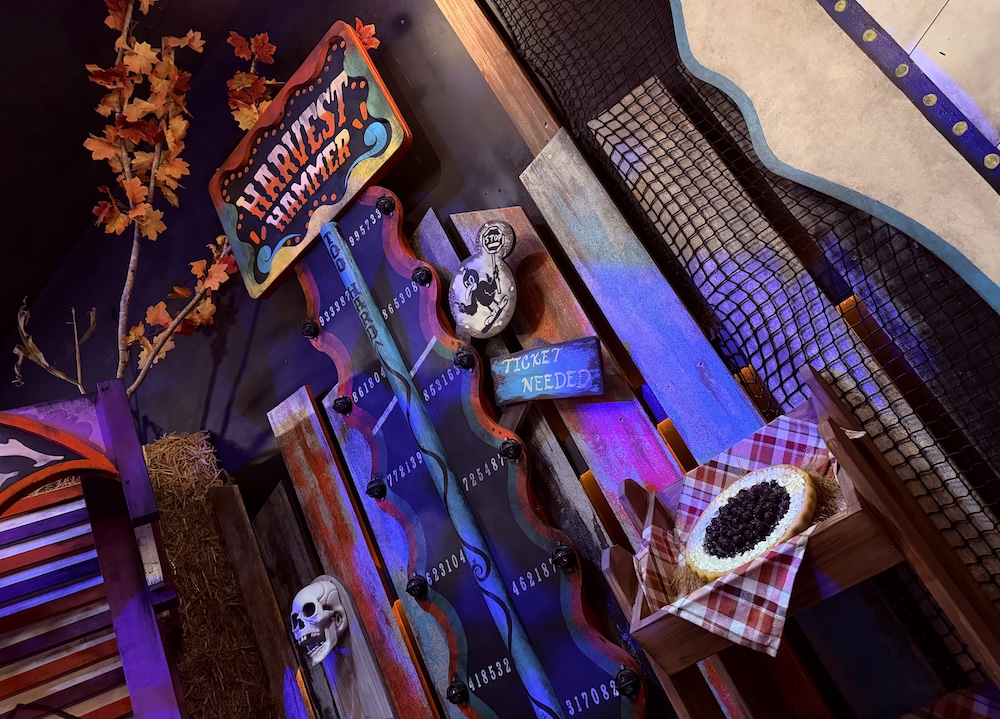 A midway hammer game in a Fall Festival.