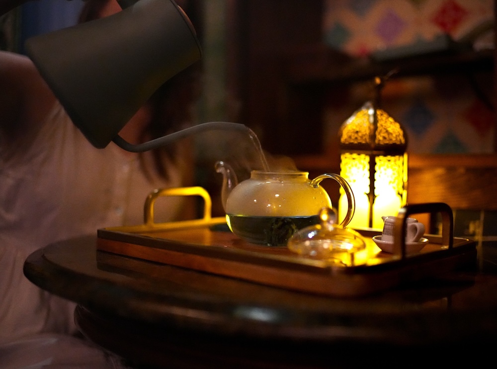 A small table with tea in a pot.