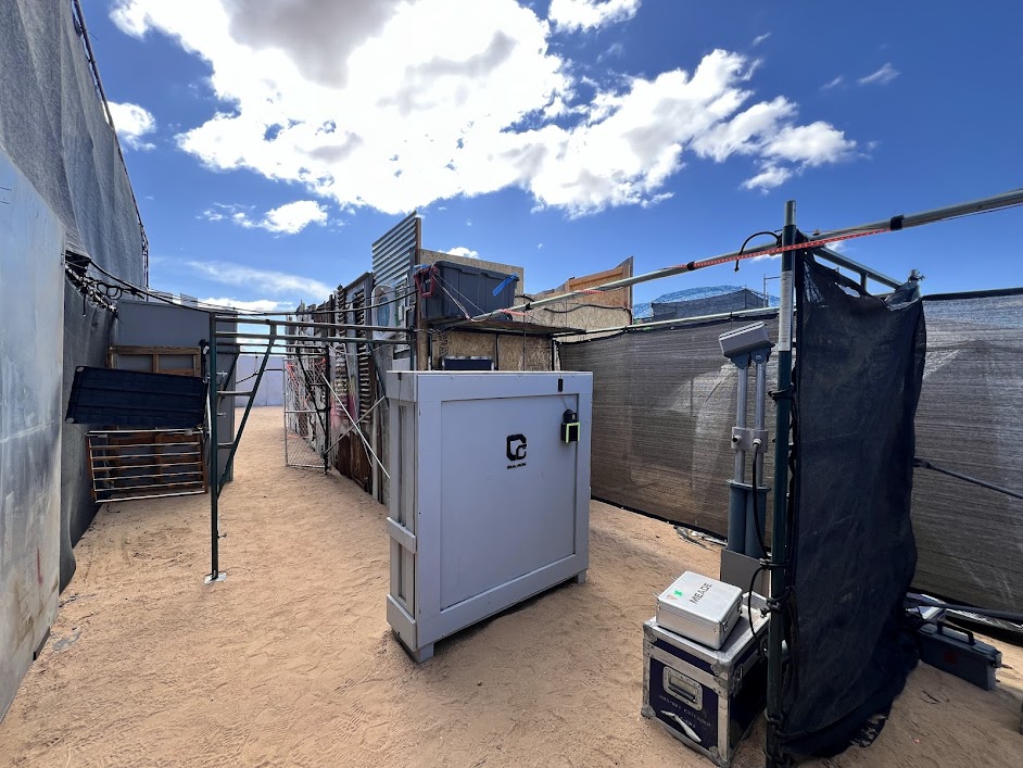 Outdoor space filled with crates, trunks, and scaffolding