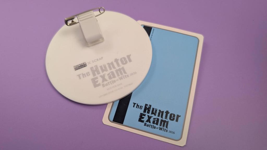 A pin badge and a card with a magstripe labelled with The Hunter Exam.