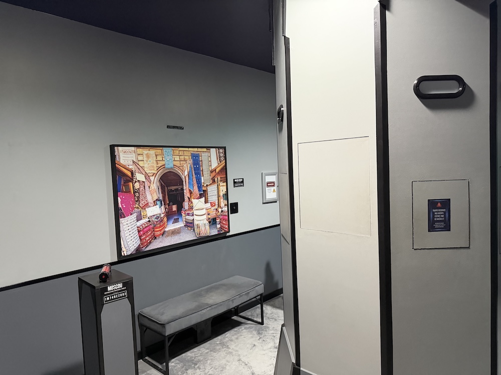 An unusual pillar with compartments built into the side, surrounded by art from different places and times.