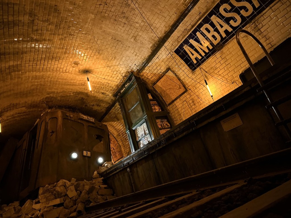 An abandoned train station with a crashed train.