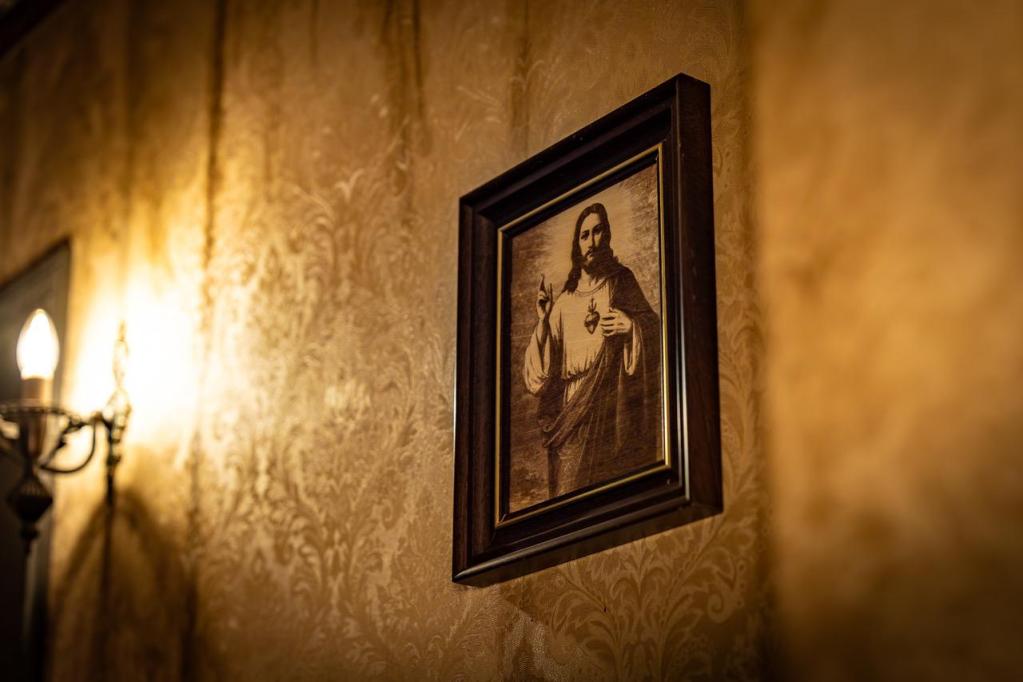 A framed rendering of Jesus on a wall