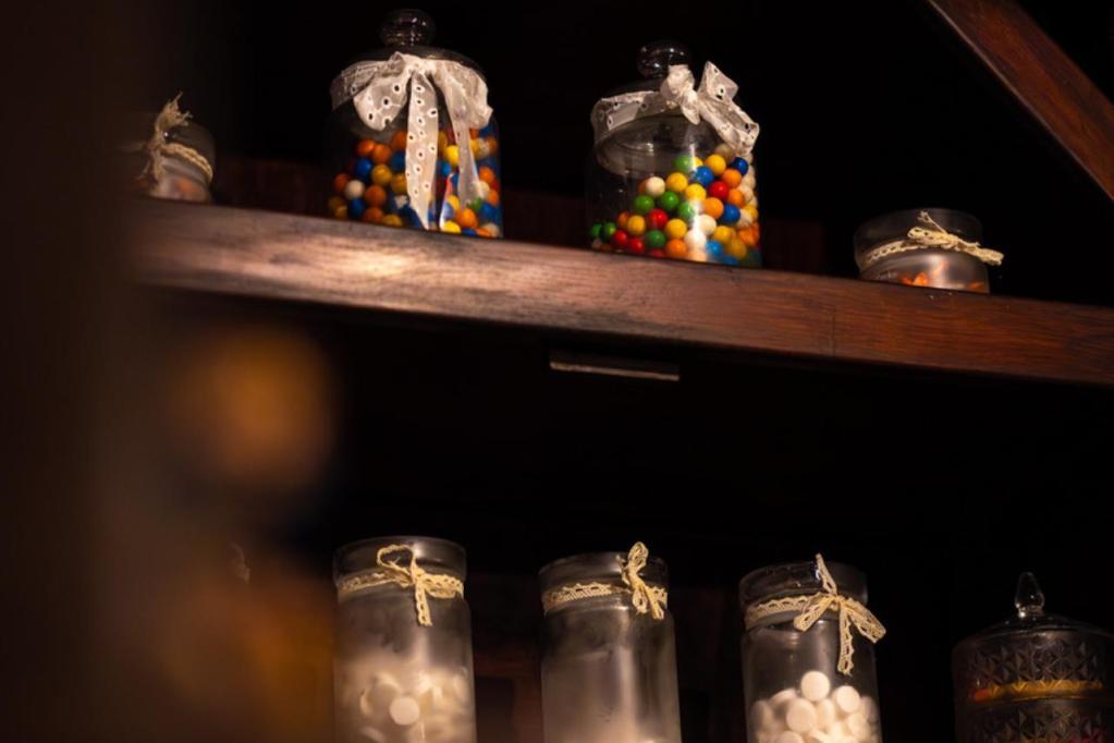 Two shelves of glass jars filled with colorful candy