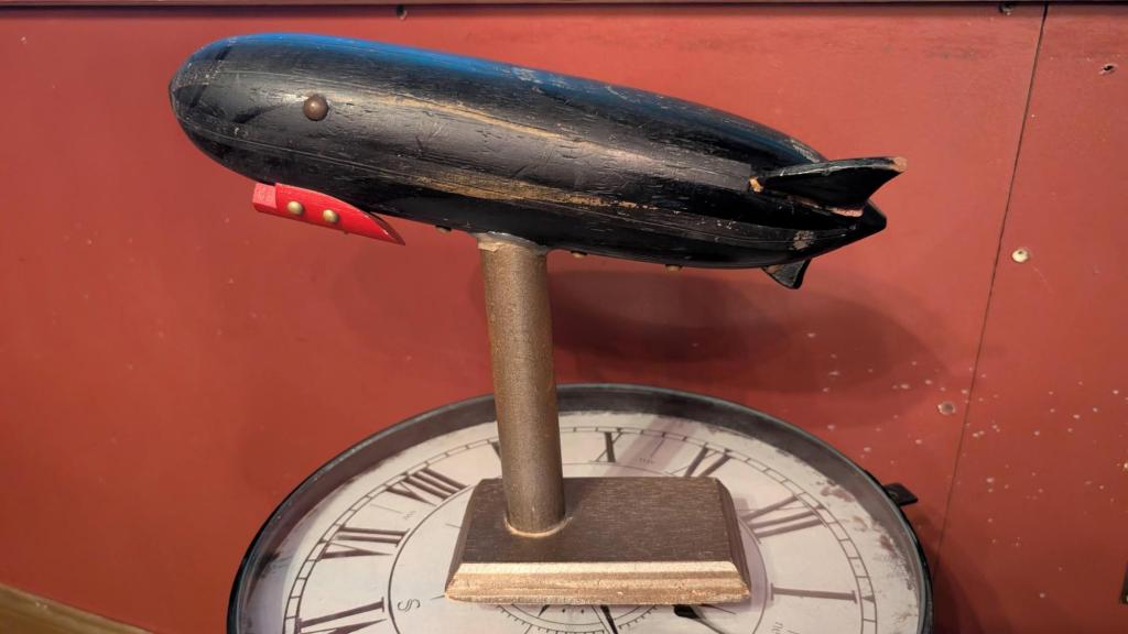 A close up of a wooden zeppelin sculpture