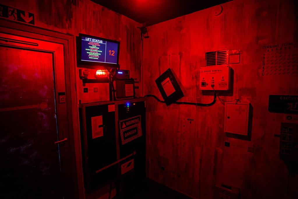 A dimly lit elevator shaft with a screen full of various errors