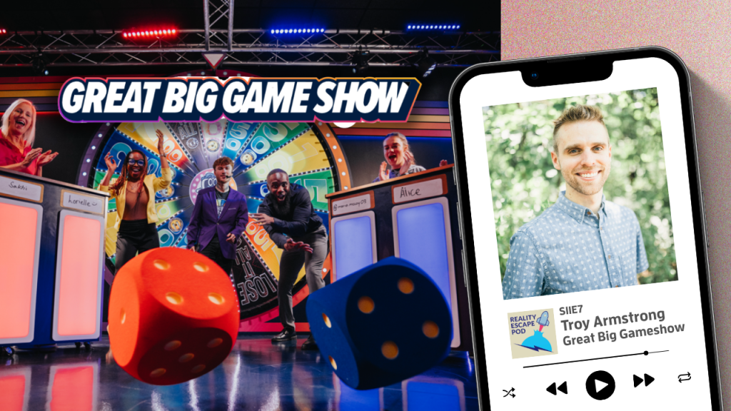 iphone with image of man with blonde hair, very short beard, blue eyes, smiling, in a button down patterned blue shirt. image of contestants rolling giant dice in a game show, with a giant wheel of fortune style wheel behind them.