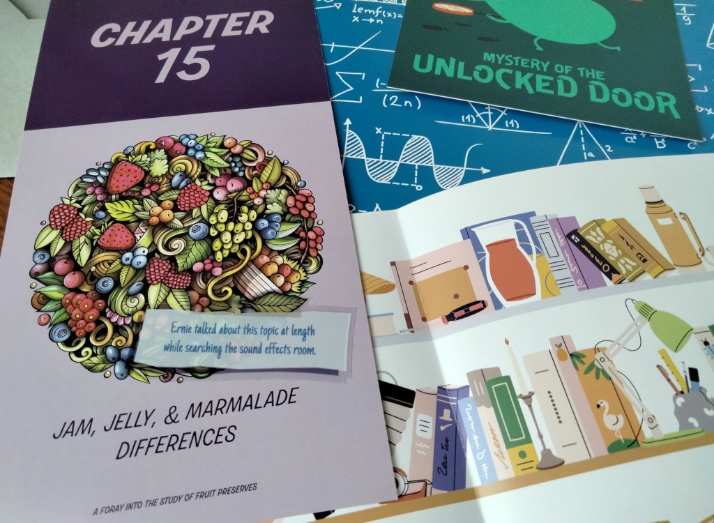 Various colorful paper game materials, focusing on "Chapter 15: Jam, Jelly, & Marmalade Differences" and an illustration of books and other items on a shelf
