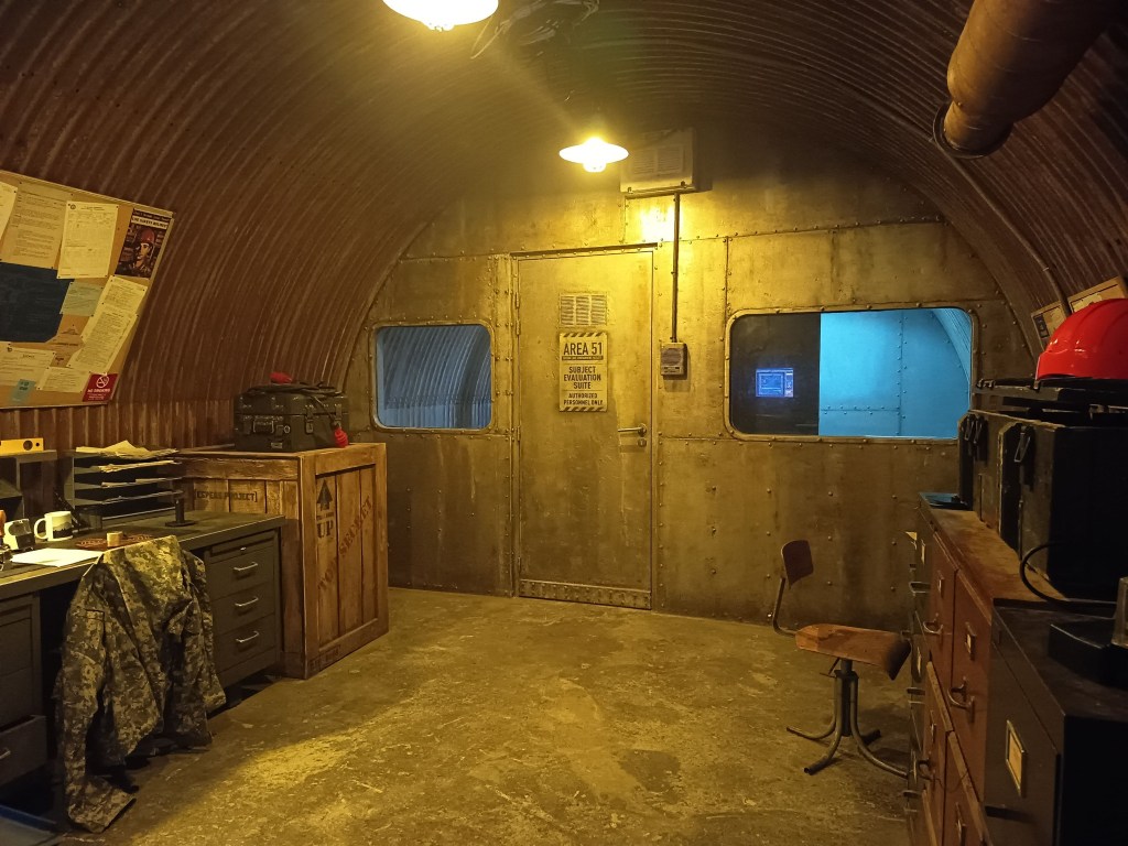 area 51 bunker with vintage desks, crates and military equipment