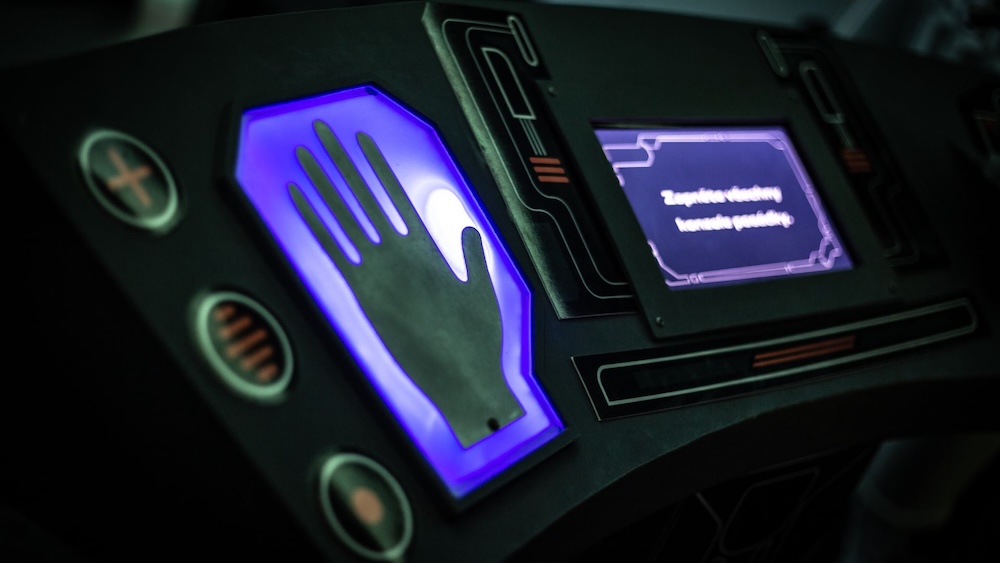 A handprint identification station at the helm of a starship.