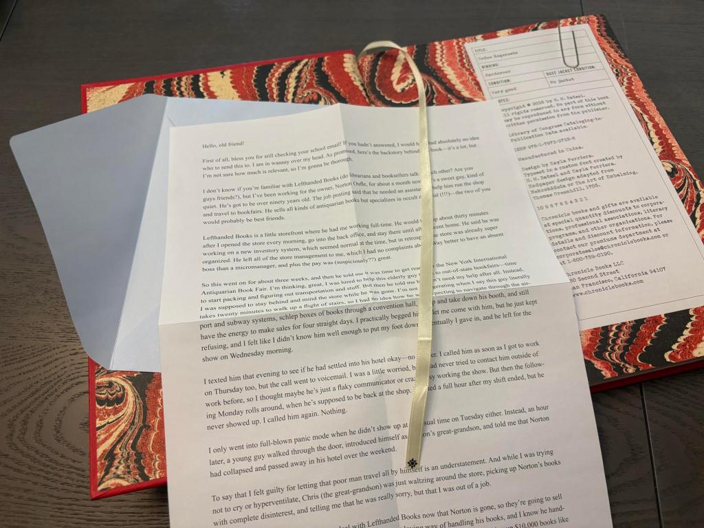 An open book with a swirling, marbled background of red, black, and white. A blue envelope is affixed to the left side, and the right side boasts a graphic of a paperclip appearing to hold the publication information. Atop the book rests an unfolded letter printed with black modern font on a white sheet of paper.