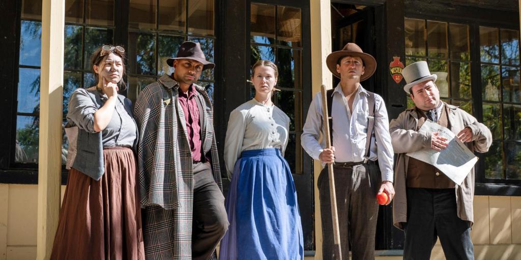 A group of 1800s characters standing in front of a building