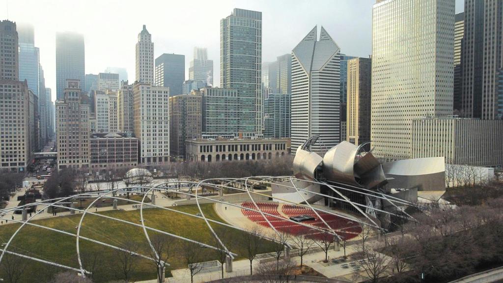 An aerial winter cityscape of Chicago, Illinois, showing the tall buildings of the skyline with a park in the foreground.